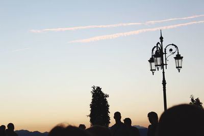 Silhouette of traditional windmill against sky