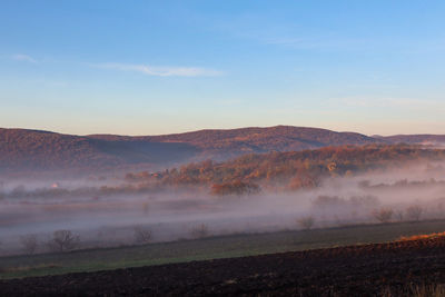 Scenic view of landscape against sky during sunrise 