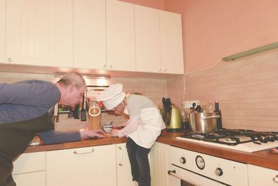 Daughter and father in the kitchen preparing spaghetti to dinner