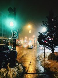 Illuminated city street against sky at night