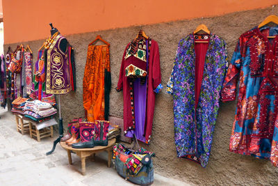 Various clothes hanging on wall at market stall