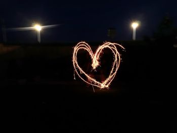 Light trails on heart shape at night