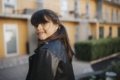 Portrait of happy smiling girl in leather jacket