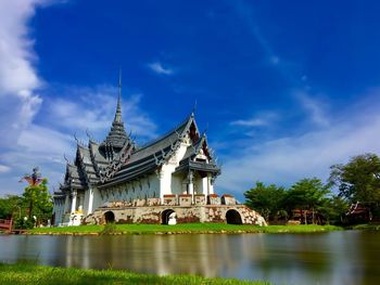 View of lake with pagoda against sky