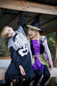 Happy halloween. funny kids brother and sister have fun in carnival costumes indoors.