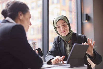 Two businesswomen sitting in cafe