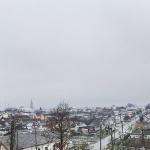 Houses in city against clear sky during winter