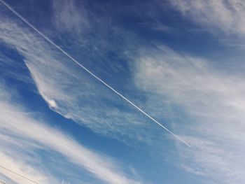 Low angle view of vapor trail in blue sky