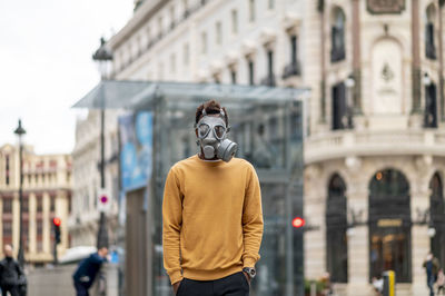 Rear view of man standing on street in city