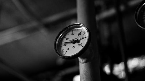 Low angle view of temperature gauge on machinery