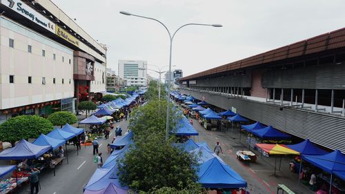 Crowd in city against sky