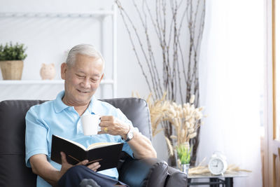 Man looking at camera while sitting on chair