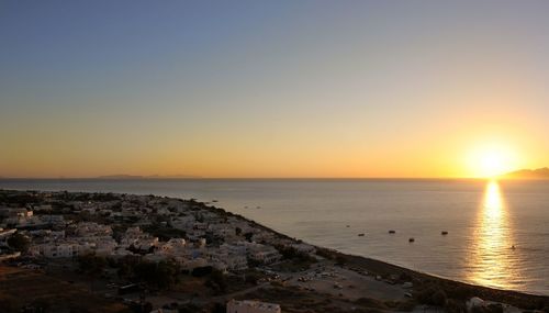 Scenic view of sea against clear sky at sunset