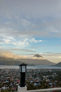 Scenic view of town by sea against sky