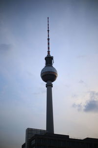 Low angle view of communications tower against sky