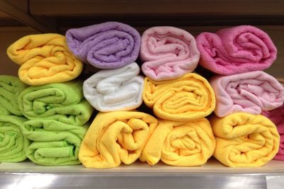 Close-up of stacked colorful towels on shelf