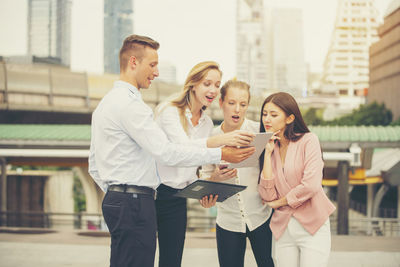 Group of people on mobile phone in city