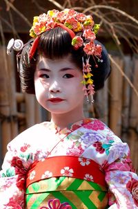 Little girl dressed in traditional clothing looking away