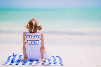 Rear view of child on beach