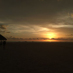 Scenic view of beach against sky during sunset