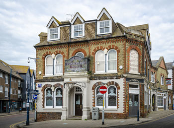 Building by road against sky