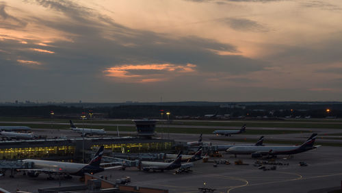 High angle view of airport runway against sky at sunset