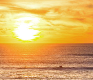 Scenic view of sea against orange sky