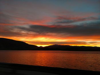 Scenic view of lake against romantic sky at sunset