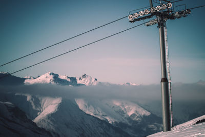 Low angle view of snow covered mountain against sky
