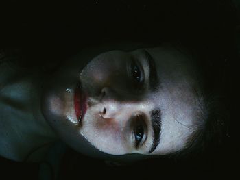 Directly above portrait of young woman in water