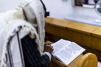 Side view of person reading book