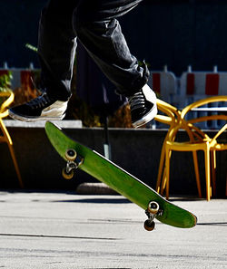 Low section of man skateboarding on street