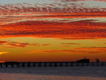 Scenic view of sea against orange sky