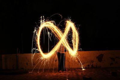 Low angle view of firework display at night