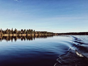Scenic view of lake against blue sky