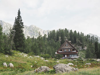 Built structure by trees against sky