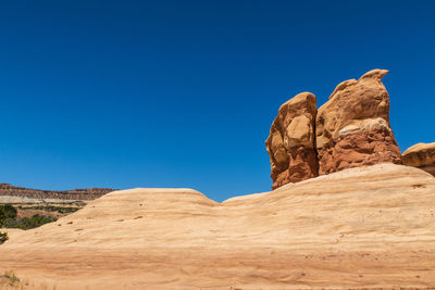 Low angle view of rock formations against blue sky