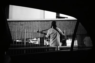 Rear view of people playing piano