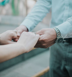 Close-up of man holding hands