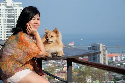 Woman sitting watching the view with a dog