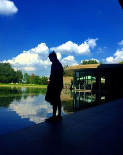 Rear view of man overlooking calm sea