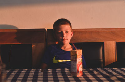 Portrait of boy sitting at home