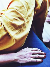 High angle view of woman lying on hand