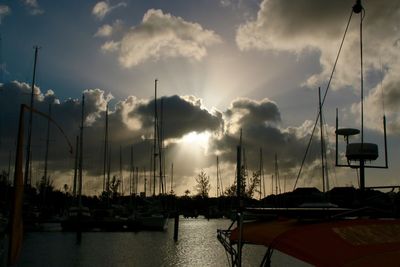 Sailboats in sea against sky during sunset