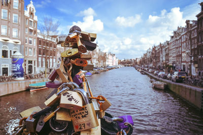 Love locks in a bridge crossing a river in amsterdam city.