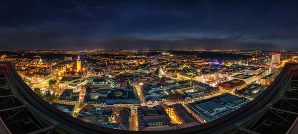 High angle view of city lit up at night