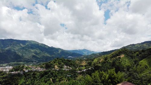 Scenic view of mountains against cloudy sky