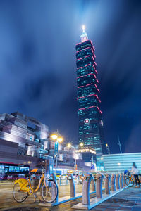 Illuminated buildings against sky at night