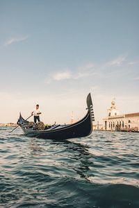 Boat sailing in sea against sky