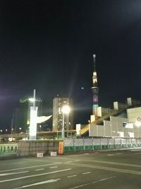 Illuminated city against sky at night